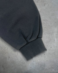 Detail view of distressed cuff on HIKIKKOMORI CONDITION — Hoodie | Heavyweight French Terry in faded black