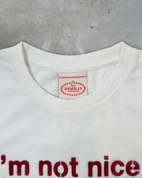 Detail view of tag on I'M NOT NICE I HURT PEOPLE — Baby Tee in vintage white